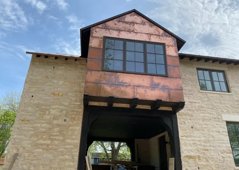 Copper metal panel facade on a stone building for Metal Roof Coating in Tuscumbia