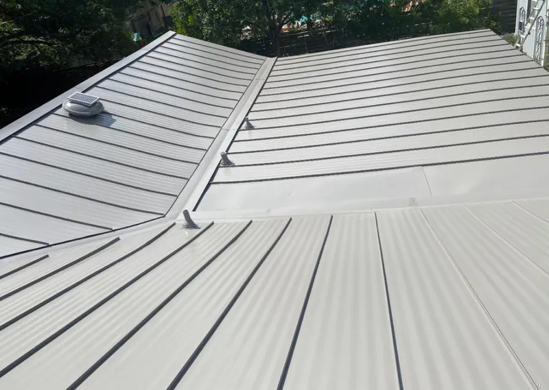 Solar attic fan installed on a metal roof for Roof Ventilation in Tuscumbia